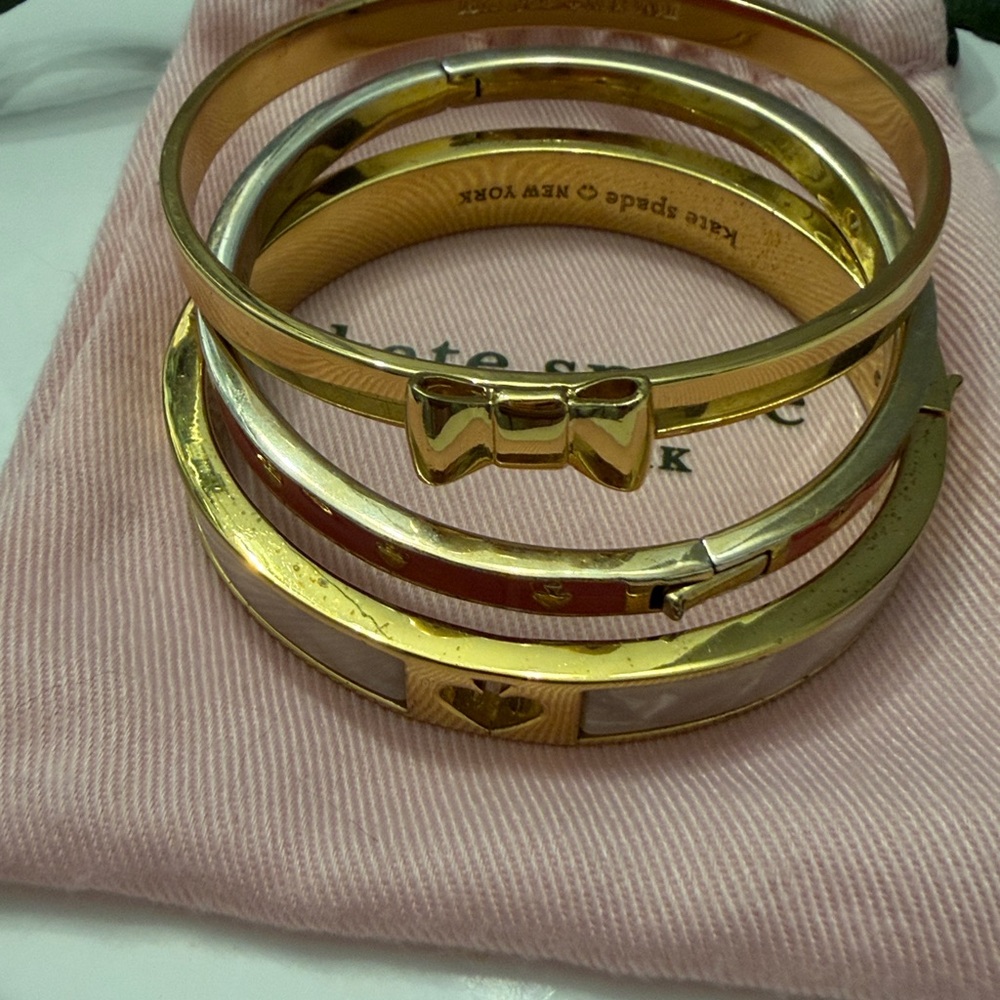 Three!!! Kate Spade Bangles. Gold/ Cream, Red Heart and gold bangle with bow.